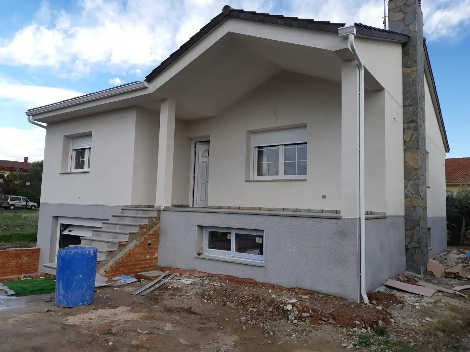 La vivienda terminada con monocapa china blanca y zócalo gris